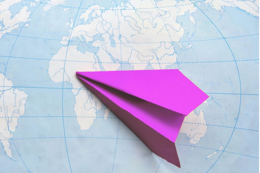 paper plane on a map depicting travel